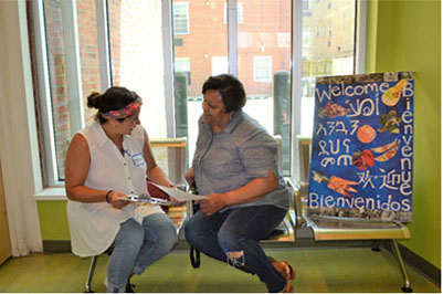 Attorney Catalina Martinez (left) meets with a pro bono client at an Advice & Referral Clinic