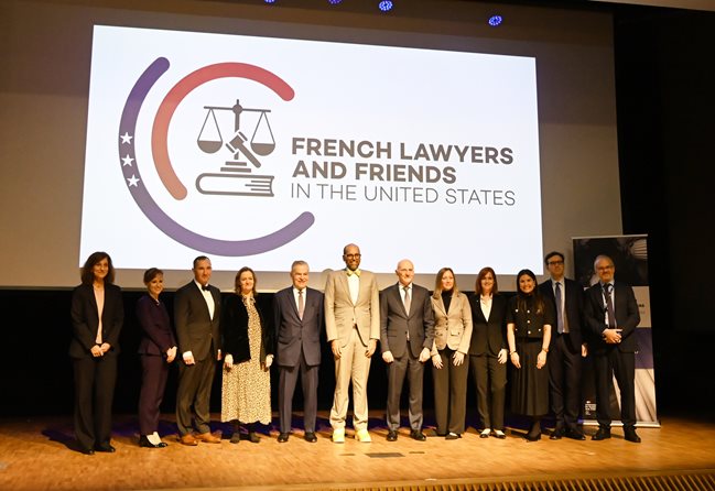 People standing in front of a screen that reads French Lawyers and Friends in the United States