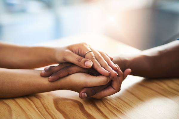 hands touching across table