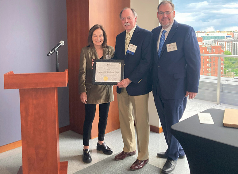 Judge Richard Linn (center) receives the Champion of Intellectual Property Award from fellow Federal Circuit Judge Kathleen M. O’Malley and D.C. Bar Intellectual Property (IP) Community Steering Committee Chair Bradley Hartman.