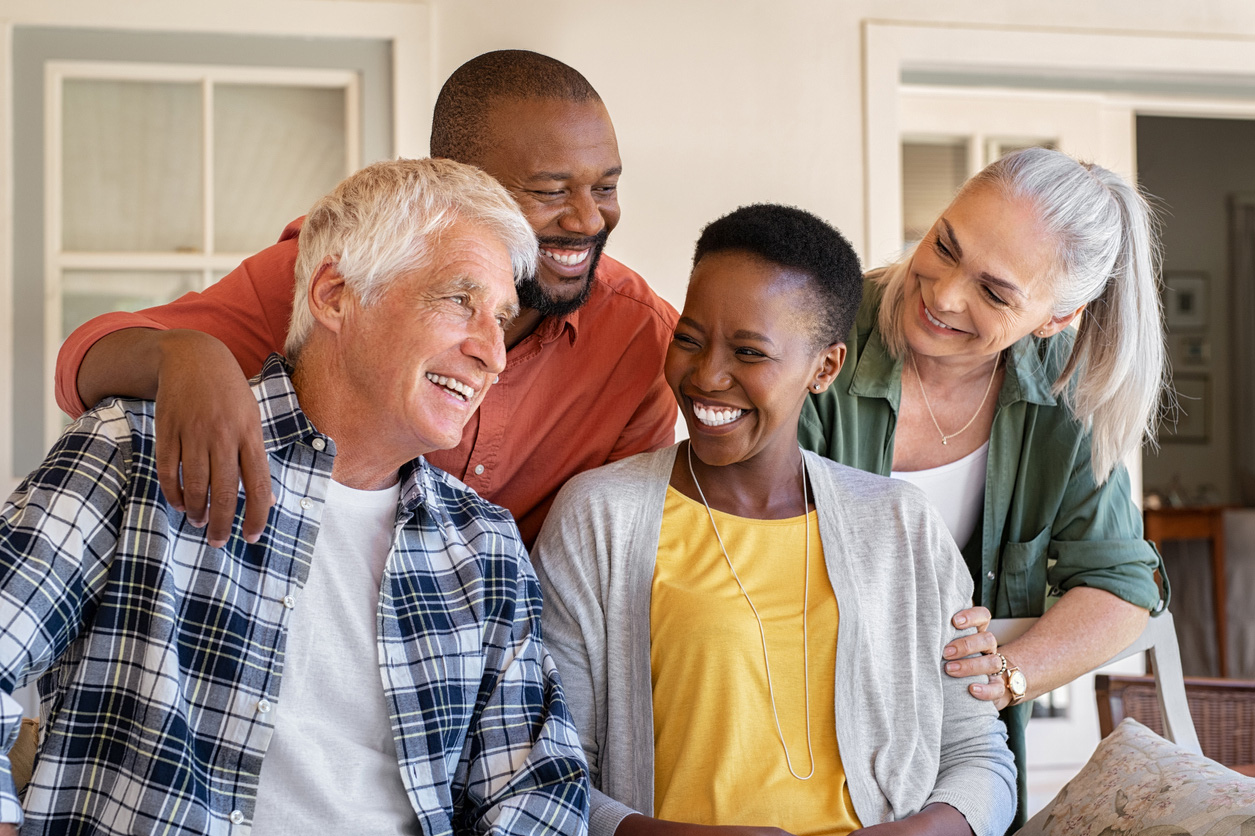 A smiling group of four people