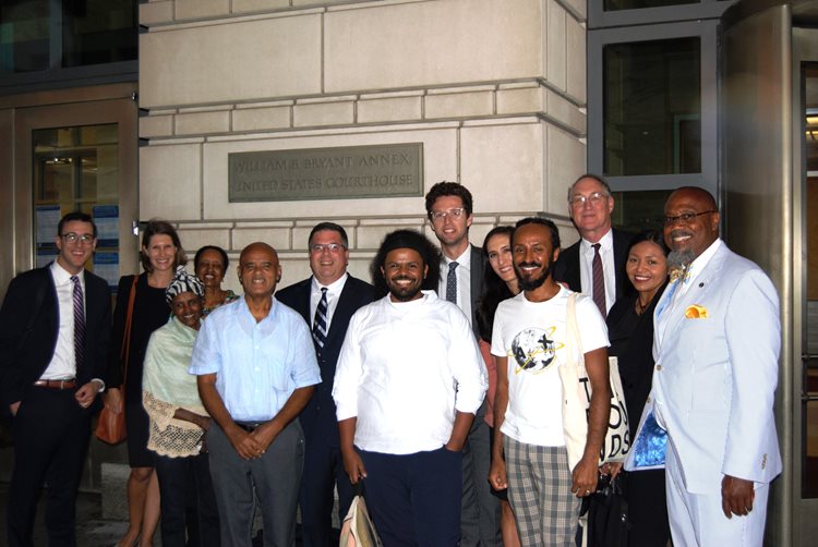 Men and women outside courthouse.